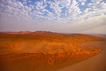 Bright orange sand dunes of Namibia’s Namib Desert, aerial view