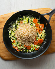 Rice paella with vegetables and salmon. Step-by-step recipe to learn how to cook.