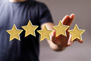 Hand of a person touching golden stars representing a 5-star rating. Perfect for feedback, review,...