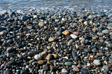 Pebbles on the seashore as an abstract background. Sea pebbles on the beach, natural background, nature series