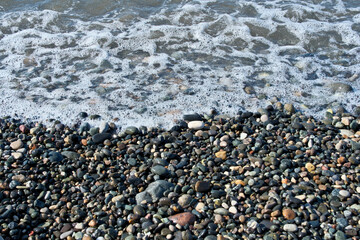 Pebbles on the seashore as an abstract background. Sea pebbles on the beach, natural background, nature series