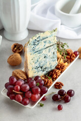 Gorgonzola cheese with walnuts, red grapes, and thyme.