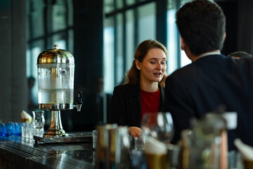 Business professionals networking at rooftop bar after work, sharing drinks and smiles in a relaxed atmosphere, symbolizing teamwork, communication, and modern business lifestyle.