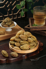 Traditional Chaoshan Dried Preserved Olives in Wooden Bowls with Tea Setup