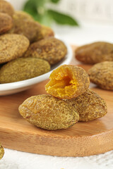 Chaoshan Candied Dried Fruits and Licorice Olives Traditional Asian Snacks on Wooden Board