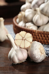 Fresh Shandong Farm Garlic Bulbs - Whole and Cross-Section Sliced on Rustic Wooden Table with Basket Collection