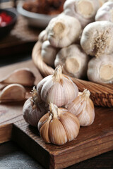 Fresh Garlic Bulbs and Cloves on Wooden Cutting Board - Cooking Ingredients