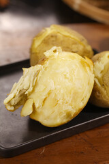 Blooming Sweet Potatoes from Gansu Province China - Baked Golden Potato Halves on Dark Plate