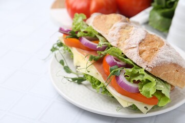 Delicious ciabatta sandwich with prosciutto, cheese and vegetables on white tiled table, closeup. Space for text