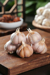 Fresh White Garlic Bulbs and Cloves on Wooden Cutting Board - Kitchen Cooking Ingredients