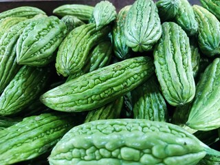 bitter melon, also known as bitter gourd. It is a tropical vine that is a member of the cucumber family