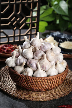 Fresh White Garlic Bulbs in Wicker Basket - Traditional Asian Kitchen Ingredients