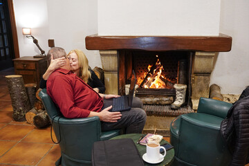 Romantic couple Kissing by the Fireplace in Winter