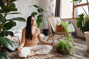 Finding inner peace through mindful yoga in a serene home filled with greenery