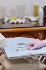 Dentist hand preparing sterile dental instruments for oral care