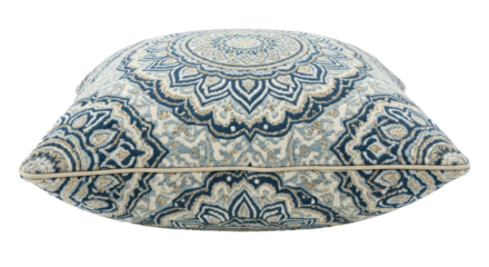 A blue and white patterned pillow with a floral design on a white background.