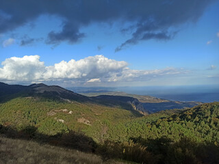 beautiful green mountains landscape with clouds upper them. autumn sunny day