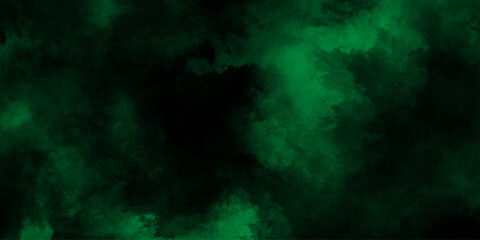 Abstract dark green or black  watercolor texture, dresembling a nebula or cosmic cloud formation, lime green smoke or fog on a black background, old vintage grunge design green Christmas background.