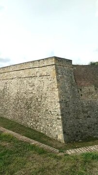 Belgrade Fortress Clock Tower and layered medieval walls with moat and distant Zindan Gate. Concept of military heritage, Balkan fortifications, cultural tourism, and historical architecture of Serbia