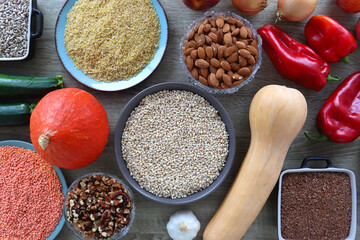 Assortment of various healthy fruits, vegetables, grains and legumes. Top view, wooden background.