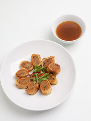 Gohyong or Ngohiong served with sweet and spicy sauce on white plate