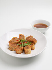 Gohyong or Ngohiong served with sweet and spicy sauce on white plate