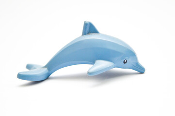 Children's small bathtub rubber dolphin isolated on white background. A small child's toy in the shape of a dolphin. Front view of a squirting rubber dolphin bath toy. Squeaky rubber dolphin toy.