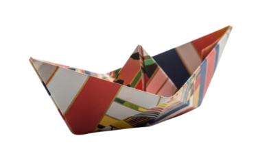 A small paper boat with colorful stripes isolated on a white background cutout transparent png