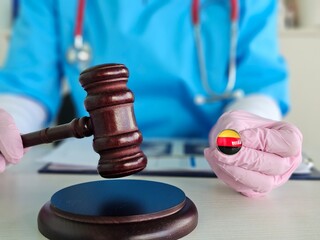 Legal and medical professions converge as a gavel is held beside a medical badge during a meeting...