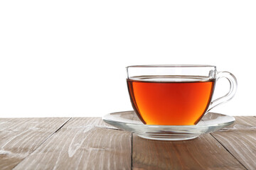 Cup of aromatic black tea on wooden table against white background