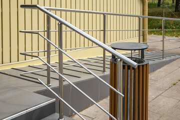 Stainless steel ramp handrails at building entrance accessibility, urban infrastructure