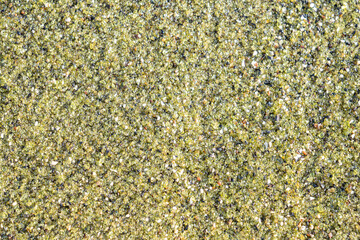 Olivine Crystals in Lava Rock. This is the source of the green sand found on the green sand beach.  located near South Point, in the Kaʻū district of the island of Hawaiʻi.  near Papakōlea Beach 