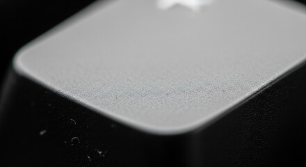 Extreme Macro Close-up of Textured Keyboard Key Surface with Subtle Dust Particles