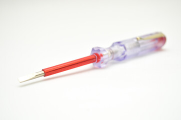 Electrical tester screwdriver isolated on a clean white background. Essential tool for electricians to check voltage, repair, and conduct diagnostics. Professional engineering equipment.