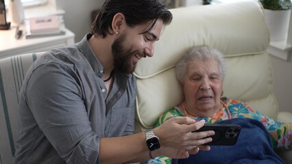 Grandson and Grandmother Share Joyful Memories in a Cozy Living Room Setting