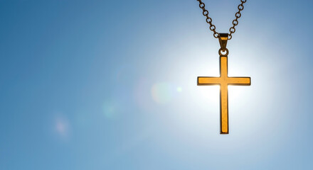Golden cross silhouetted against bright sun in blue sky. Christian symbol of faith, hope, and religion. Spiritual concept with copy space for text