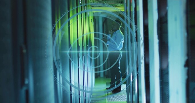 Mid adult African American technician examining server rack in data center, with HUD overlay