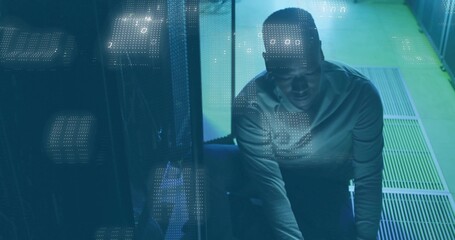 Squatting technician plugging cables at server rack in data center, binary code overlay, copy space