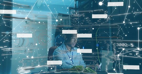 Connecting ethernet cables tech wearing checkered shirt monitoring network on laptop in server room