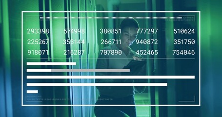 Network engineer wearing business attire monitoring data in server aisle, with tablet, server racks