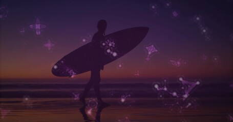 Walking silhouette surfer carrying surfboard on wet sand shore at dusk, with glowing constellations