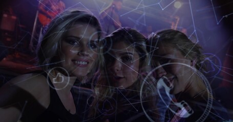 Standing mother and daughters posing at concert venue, with stage lights and digital graphics