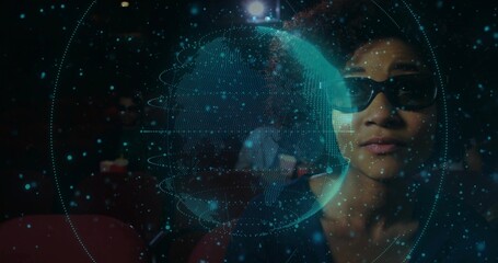 Woman wearing VR glasses inspecting globe and digital points in theater, copy space
