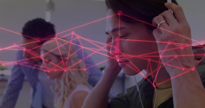 Adjusting headphones Asian man wearing olive jacket at office, with network graph, copy space