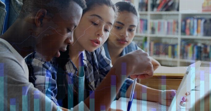 Collaborating classmates reviewing notes at study table in library, with laptop tablet notebook pen