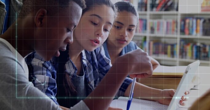 Collaborating students leaning over notebooks and laptop at school library table, with bookshelves