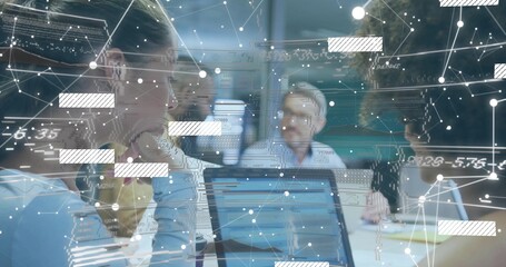 Collaborating professionals reviewing laptop charts in conference room, with network overlay
