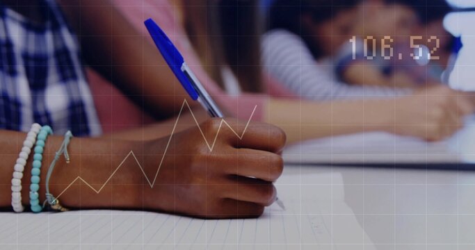Writing child holding blue ballpoint pen and wearing beaded bracelets at school desk, lined paper