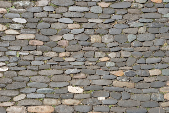 Sidewalk made of old small cobblestones