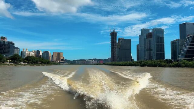 Macau (Macao) city skyline during day time with Macau tower landmark and Ponte de Sai Van Bridge, China.